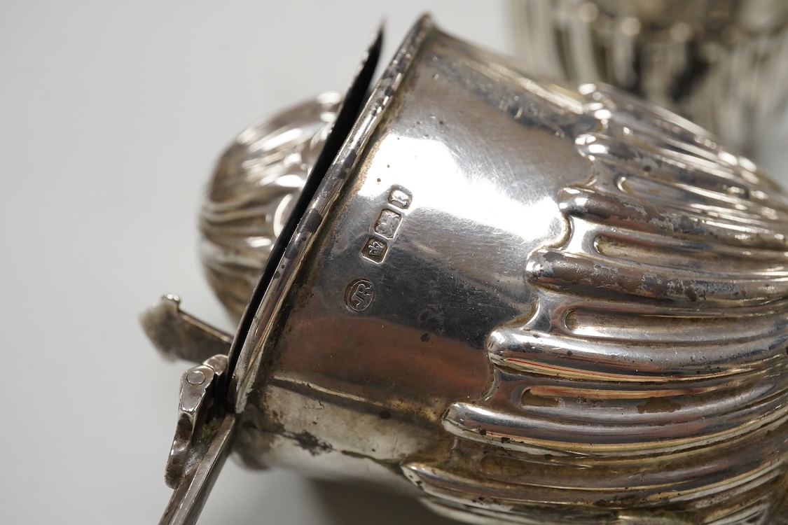 A George V silver octagonal sugar caster, Viners Ltd, Sheffield, 1932, 18.2cm, an Edwardian silver three piece condiment set by John Round, a silver napkin ring and three silver spoons including a dessert spoon by Peter,